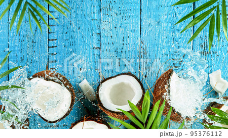 Freeze Motion Shot of Falling Coconuts on Wooden Background, top shot Freeze Motion Shot of Falling Coconuts on Wooden Background, top shot 95376112