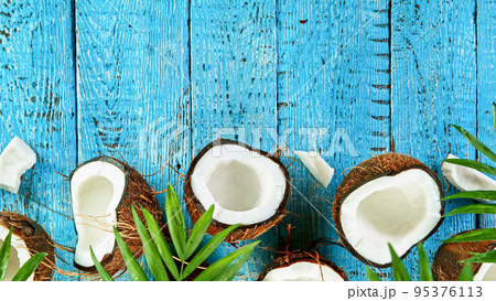 Freeze Motion Shot of Falling Coconuts on Wooden Background, top shot Freeze Motion Shot of Falling Coconuts on Wooden Background, top shot 95376113