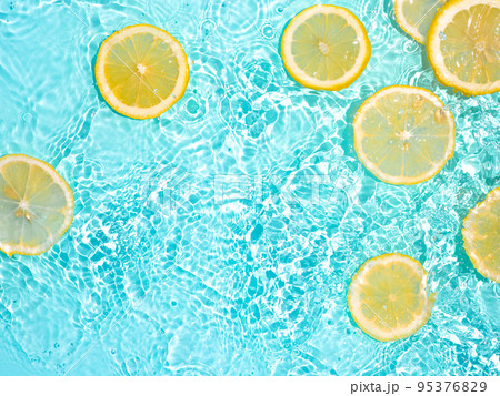 Lemon slices in clean transparent water, blue bg 95376829