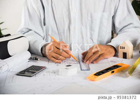 Architectural building design and construction plans with blueprints paper project plans VR glasses 95381372