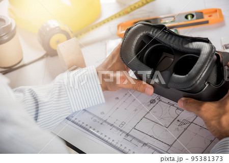 Architectural building design hold back 3D VR glasses and construction plans with blueprints paper project plans 95381373
