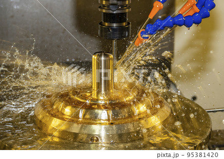 The CNC milling machine cutting the brass material part with oil coolant method. 95381420