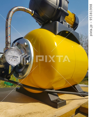 New water pumping station, household automatic station with pressure sensor, yellow color. Application of house, country house, village, cottage New water pumping station, household automatic station with pressure sensor, yellow color. Application of house, country house, village, cottage 95381998