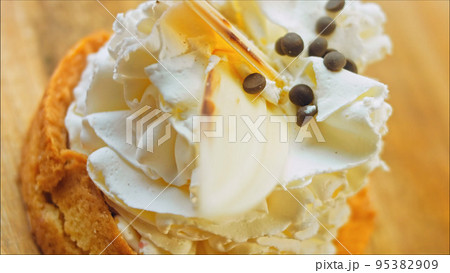 Coconut basket cake with white chocolate decorative leaves. Macro and slider shooting Coconut basket cake with white chocolate decorative leaves. Macro and slider shooting 95382909