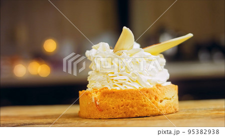 Coconut basket cake with white chocolate decorative leaves. Macro and slider shooting Coconut basket cake with white chocolate decorative leaves. Macro and slider shooting 95382938