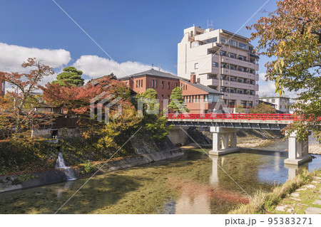 Takayama Japan, autumn landscape foliage at red Nakabashi bridge and Miyakawa river Takayama Japan, autumn landscape foliage at red Nakabashi bridge and Miyakawa river 95383271