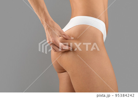 Anti Cellulite Massage. Young Slim Lady In Panties Pinching Skin On Buttocks Anti Cellulite Massage. Young Slim Lady In Panties Pinching Skin On Buttocks 95384242