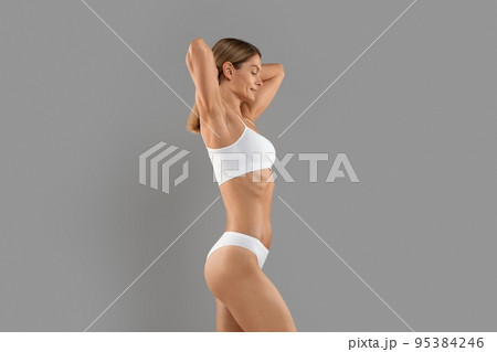 Body Sculpting. Side View Of Young Slim Female In White Underwear Body Sculpting. Side View Of Young Slim Female In White Underwear 95384246