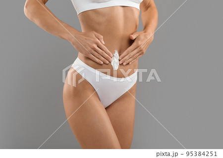 Body Care. Slim Sporty Woman Applying Moisturising Lotion On Belly Area Body Care. Slim Sporty Woman Applying Moisturising Lotion On Belly Area 95384251