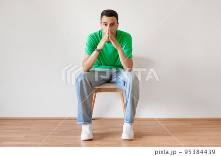 Negative emotions. Young arab guy with thoughtful face expression, feeling sad, suffering from depression Negative emotions. Young arab guy with thoughtful face expression, feeling sad, suffering from depression 95384439