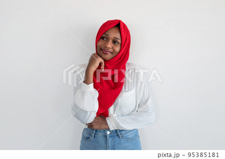 Thoughtful african american muslim woman thinking and looking aside at free space, standing over white wall background 95385181