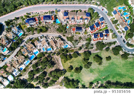 Aerial view modern suburban houses and surrounding meadows 95385656