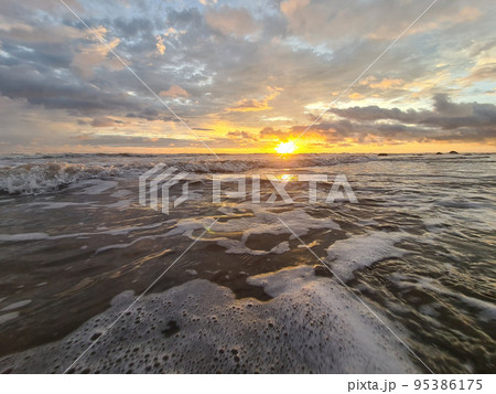 Sunset over ocean waves Sunset over ocean waves 95386175
