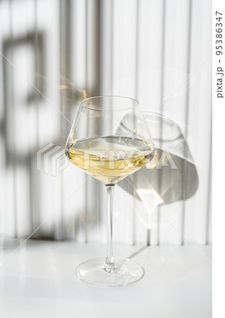 A glass of white wine A glass of white wine 95386347