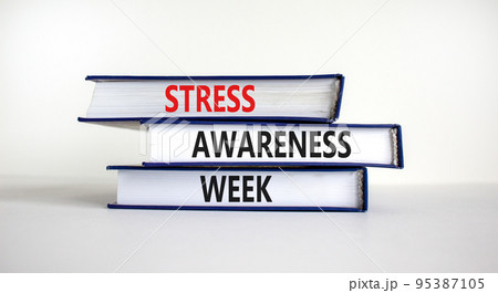 Stress awareness week symbol. Books with words 'Stress awareness week'. Beautiful white background. Psychological, business and stress awareness week concept. Copy space. Stress awareness week symbol. Books with words 'Stress awareness week'. Beautiful white background. Psychological, business and stress awareness week concept. Copy space. 95387105