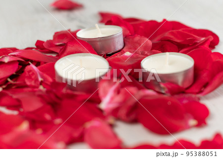 Rose petals and scented candles on the floor. 95388051