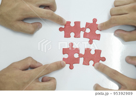 People assembling puzzles, finding solution. People assembling puzzles, finding solution. 95392989
