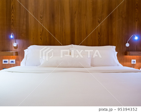 Clean Bedding sheets and pillow on natural wall room background. 95394352