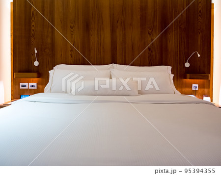 Clean Bedding sheets and pillow on natural wall room background. 95394355