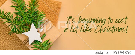 Its beginning to cost a lot like Christmas Inspiration joke quote phrase Box with New Year's gifts, wrapped in craft paper and decorated with fir branch. Holidays Banner Its beginning to cost a lot like Christmas Inspiration joke quote phrase Box with New Year's gifts, wrapped in craft paper and decorated with fir branch. Holidays Banner 95394850