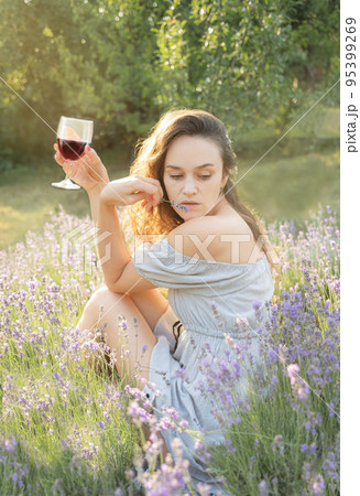 Young woman drink  wine in the sunset lavender field 95399269