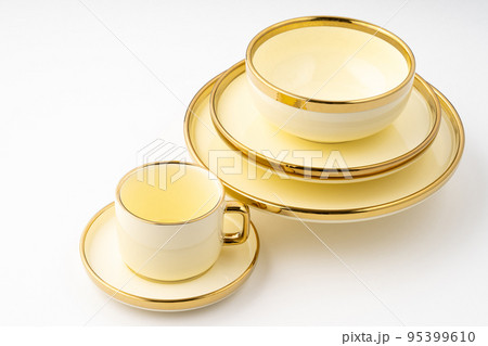 A set of golden luxury ceramic kitchen utensils on a white background A set of golden luxury ceramic kitchen utensils on a white background 95399610
