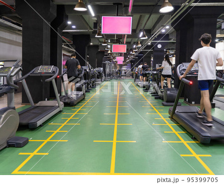 The people on treadmills in the sports complex The people on treadmills in the sports complex 95399705