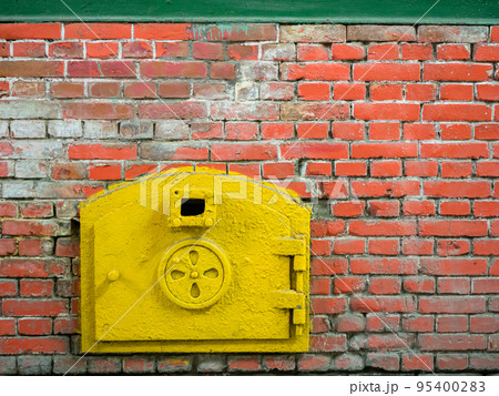 Close up of old shabby and rusty metal door of brick furnace 95400283