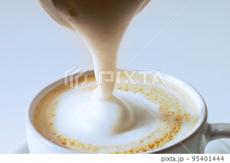 pouring cream on Cappuccino 95401444