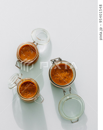 Salted caramel in glass jars, top view. Vertical Salted caramel in glass jars, top view. Vertical 95401548