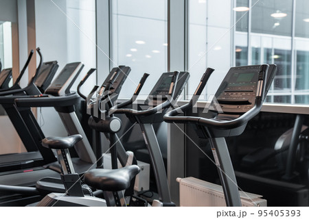 Modern light gym. Sports equipment in gym. Barbells of different weight on rack. Modern light gym. Sports equipment in gym. Barbells of different weight on rack. 95405393