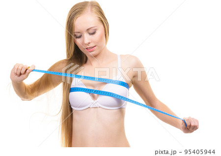 Girl measuring her chest breasts bust size Girl measuring her chest breasts bust size 95405944