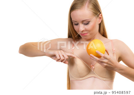 Woman small boobs puts big fruit in her bra 95408597