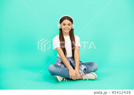 happy teen girl listen to music in wireless headphones, new technology happy teen girl listen to music in wireless headphones, new technology 95412439