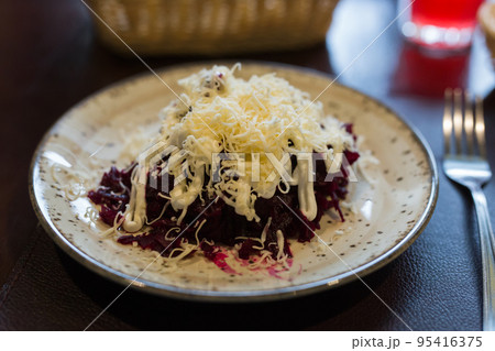 dish of beets, cheese, mayonnaise on a plate in restaurant dish of beets, cheese, mayonnaise on a plate in restaurant 95416375