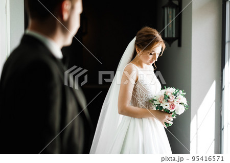 Portrait of stunning bride with long hair posing with great bouquet Portrait of stunning bride with long hair posing with great bouquet 95416571