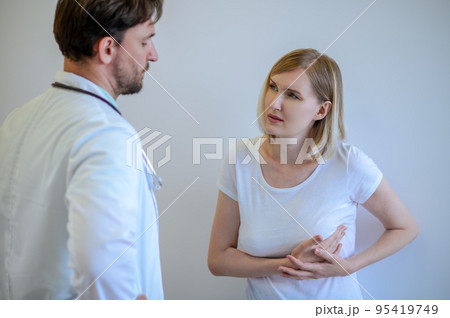 Adult woman discussing her health problems with a doctor 95419749