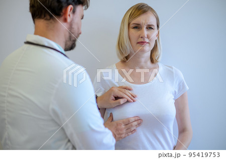 Female patient undergoing a painful breast examination 95419753