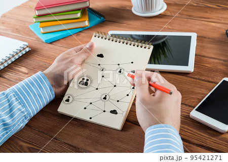 Man makes notes in a notebook Man makes notes in a notebook 95421271