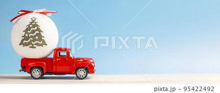 Christmas red retro car with a Christmas ball on a blue background 95422492