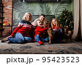 Huge family siiting on floor. Christmas time. 95423523