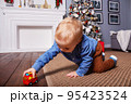 Small caucasian boy playing with fire truck.  95423524