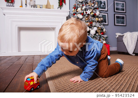 Small caucasian boy playing with fire truck.  95423524