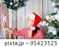 Woman in santa hat talking video call. 95423525