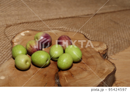 Olives and Olive Oil on wooden background 95424597