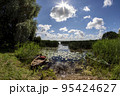 Summer lake with old boat 95424627