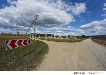 Crossroads two gravel roads and road sign 95424633