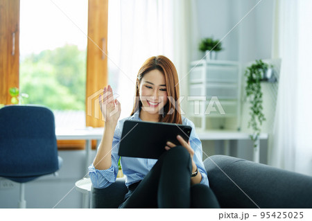 internet learning, online shopping, selling, meeting, information searching, young Asian woman using tablet mobile to work at home internet learning, online shopping, selling, meeting, information searching, young Asian woman using tablet mobile to work at home 95425025