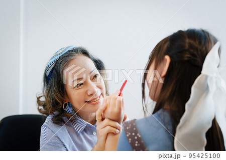 Asian portrait, grandchild granddaughter grandma grandmother and granddaughter happily join in activities to enhance skills for grandchildren. 95425100