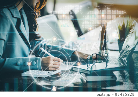 Financial planning and control concepts, women holding pen with notebook to calculate investment statements while using tablet computers to work, Using digital devices in data analysis Financial planning and control concepts, women holding pen with notebook to calculate investment statements while using tablet computers to work, Using digital devices in data analysis 95425829